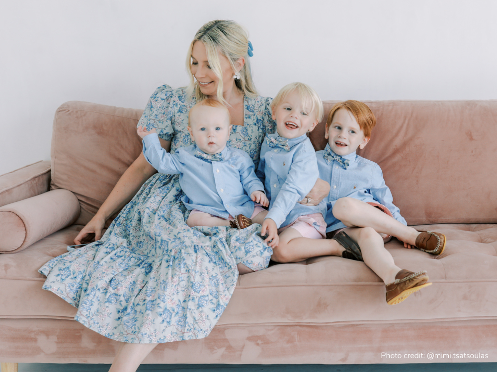 Mom and her three little boys wearing matching feminine nursing-friendly dress and boy ties